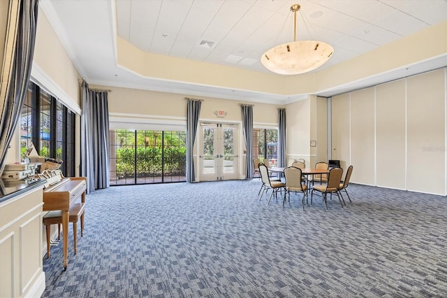 11103 Batello Dr, Venice, FL 34292 - dining area with carpet, a raised ceiling, french doors, and a decorative wall