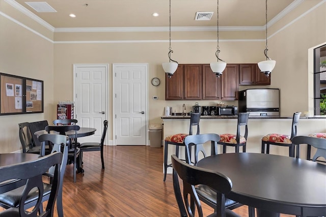 11103 Batello Dr, Venice, FL 34292 - dining area featuring dark wood-style floors and ornamental molding