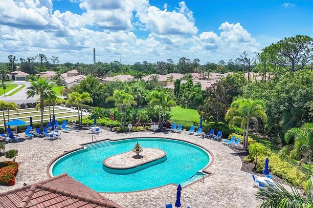 11103 Batello Dr, Venice, FL 34292 - community pool featuring view of scattered trees and a patio
