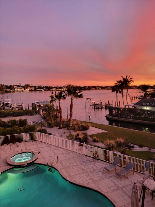 516 Tamiami Trl S Unit 303, Nokomis, FL 34275 - pool at dusk with a water view, a patio, and a pool with connected hot tub