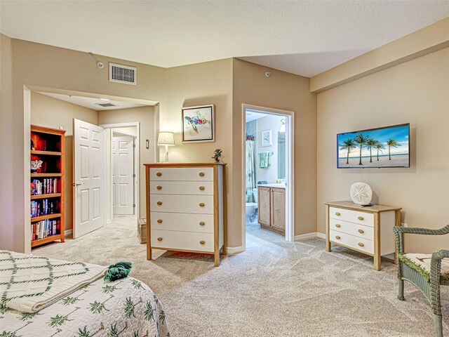 516 Tamiami Trl S Unit 303, Nokomis, FL 34275 - bedroom with carpet floors and connected bathroom