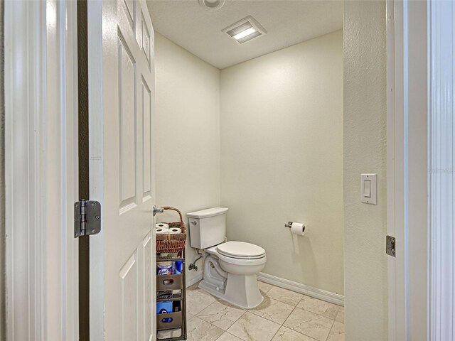516 Tamiami Trl S Unit 303, Nokomis, FL 34275 - bathroom featuring toilet and baseboards
