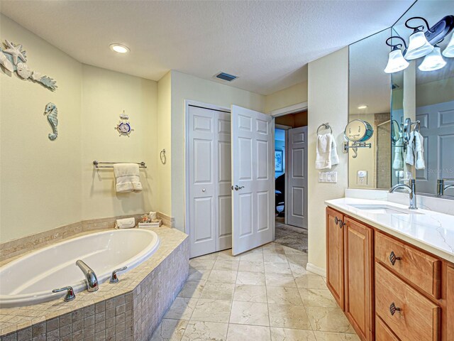516 Tamiami Trl S Unit 303, Nokomis, FL 34275 - bathroom with vanity, a bath, and a textured ceiling