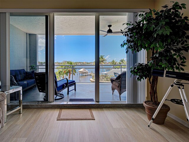 516 Tamiami Trl S Unit 303, Nokomis, FL 34275 - entryway with a water view, ceiling fan, and wood finished floors