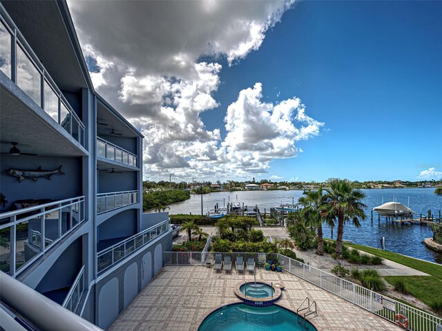 516 Tamiami Trl S Unit 303, Nokomis, FL 34275 - view of swimming pool with a water view, a patio, ceiling fan, and a pool with connected hot tub