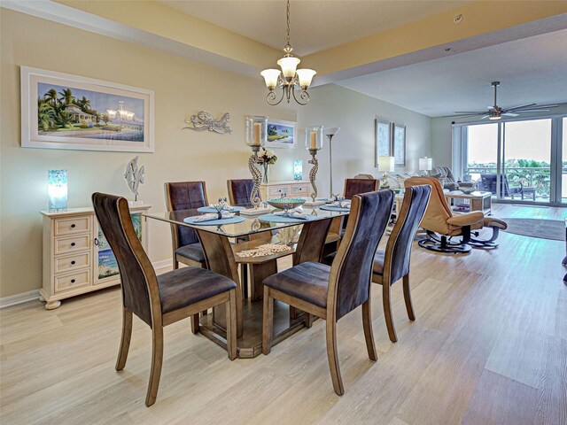 516 Tamiami Trl S Unit 303, Nokomis, FL 34275 - dining space with light wood-style flooring, a chandelier, and a ceiling fan