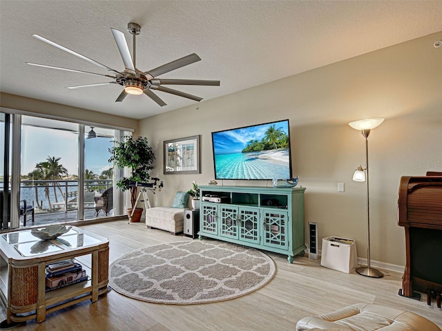 516 Tamiami Trl S Unit 303, Nokomis, FL 34275 - living room featuring a ceiling fan and wood finished floors