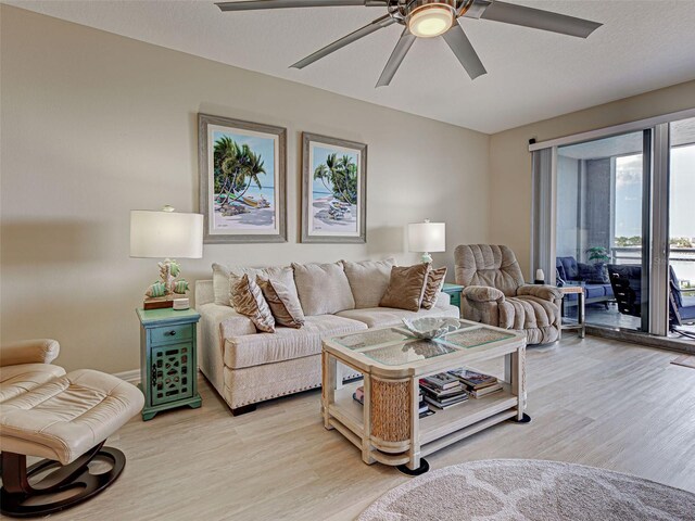 516 Tamiami Trl S Unit 303, Nokomis, FL 34275 - living room with light wood finished floors and a ceiling fan