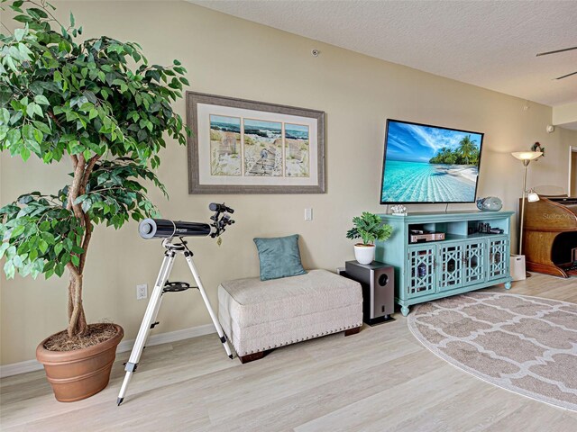 516 Tamiami Trl S Unit 303, Nokomis, FL 34275 - sitting room featuring wood finished floors and a textured ceiling