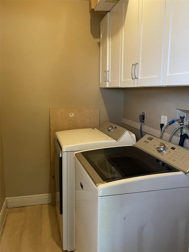 11248 Pendleton Ave Unit A & B, Englewood, FL 34224 - laundry area with washing machine and dryer, cabinet space, and baseboards