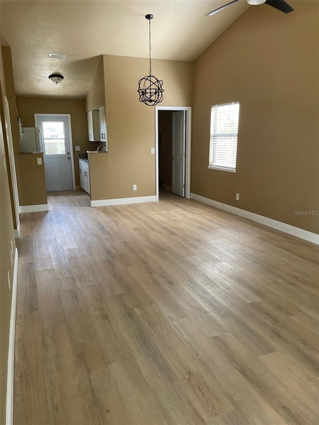 11248 Pendleton Ave Unit A & B, Englewood, FL 34224 - unfurnished dining area with light wood-style floors, baseboards, ceiling fan, and vaulted ceiling