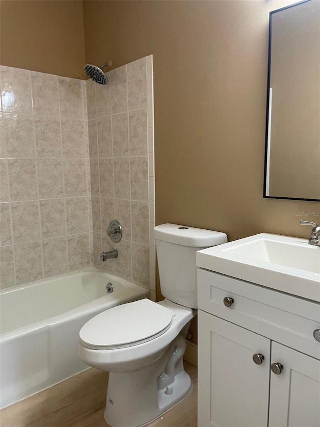 11248 Pendleton Ave Unit A & B, Englewood, FL 34224 - bathroom featuring vanity, toilet,  shower combination, and wood finished floors