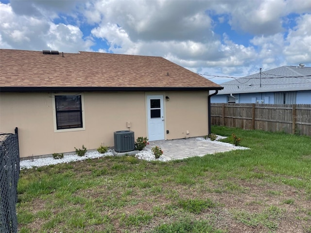 11248 Pendleton Ave Unit A & B, Englewood, FL 34224 - back of house with central AC unit, roof with shingles, a patio, and stucco siding