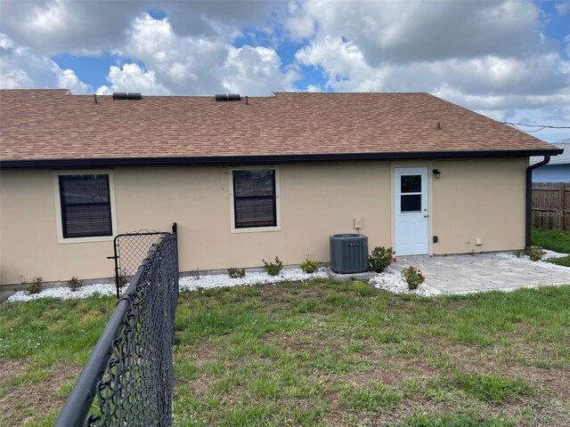 11248 Pendleton Ave Unit A & B, Englewood, FL 34224 - rear view of property with a shingled roof, stucco siding, cooling unit, and a patio area