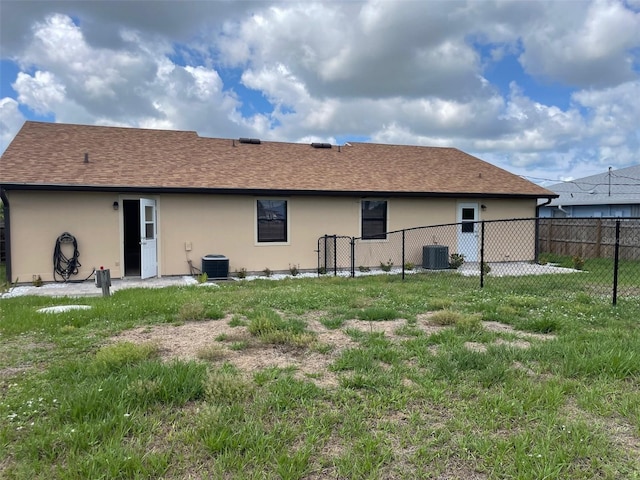 11248 Pendleton Ave Unit A & B, Englewood, FL 34224 - rear view of property featuring stucco siding, central AC, and a shingled roof