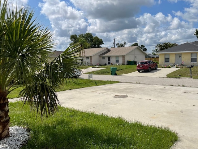 11248 Pendleton Ave Unit A & B, Englewood, FL 34224 - view of grassy yard featuring driveway and a residential view