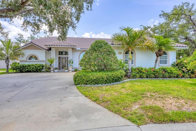 188 Grand Oak Cir, Venice, FL 34292 - view of front of property featuring stucco siding, driveway, a tiled roof, and a front lawn