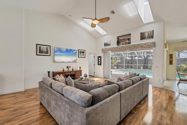 188 Grand Oak Cir, Venice, FL 34292 - living room with wood finished floors, a skylight, high vaulted ceiling, and ceiling fan