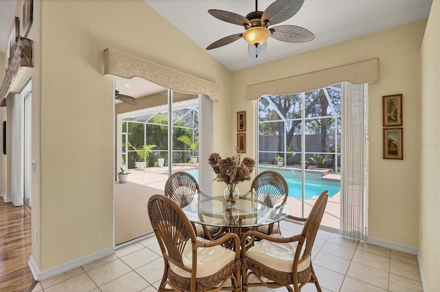 188 Grand Oak Cir, Venice, FL 34292 - dining room featuring a sunroom, ceiling fan, vaulted ceiling, healthy amount of natural light, and light tile patterned floors