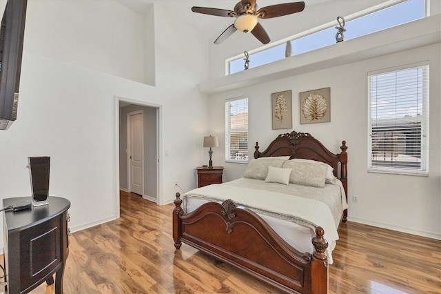 188 Grand Oak Cir, Venice, FL 34292 - bedroom featuring wood finished floors, a high ceiling, and ceiling fan