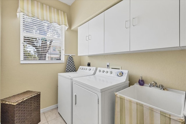 188 Grand Oak Cir, Venice, FL 34292 - laundry room featuring washing machine and clothes dryer, cabinet space, and light tile patterned floors