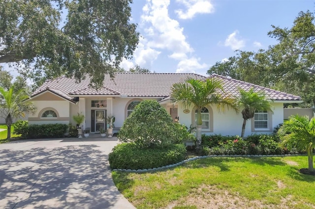 188 Grand Oak Cir, Venice, FL 34292 - view of front facade featuring a tiled roof, stucco siding, and driveway