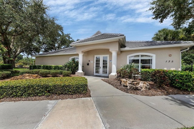 188 Grand Oak Cir, Venice, FL 34292 - view of front of house featuring french doors, stucco siding, and a tiled roof