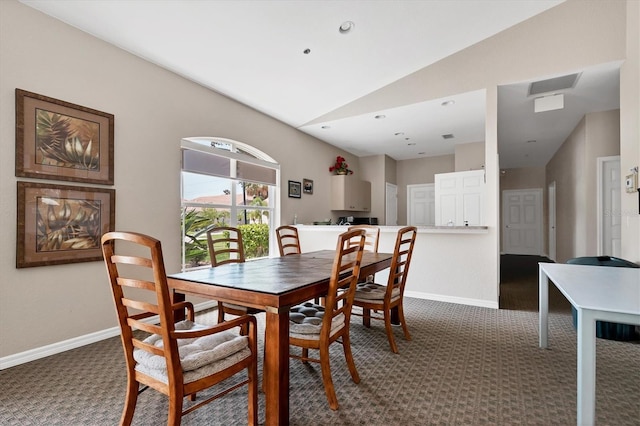 188 Grand Oak Cir, Venice, FL 34292 - carpeted dining space with lofted ceiling and baseboards