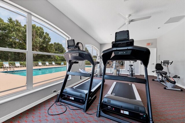 188 Grand Oak Cir, Venice, FL 34292 - workout area with carpet flooring, vaulted ceiling, and a ceiling fan