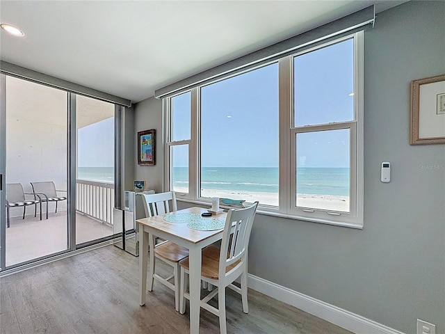 1100 Tarpon Center Dr Unit 503-5C, Venice, FL 34285 - dining space featuring wood finished floors, a water view, and baseboards
