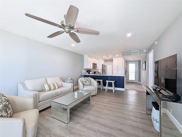 1100 Tarpon Center Dr Unit 503-5C, Venice, FL 34285 - living room featuring light wood finished floors, baseboards, recessed lighting, and ceiling fan