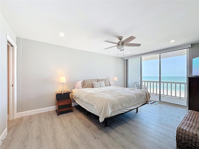 1100 Tarpon Center Dr Unit 503-5C, Venice, FL 34285 - bedroom with access to outside, light wood-type flooring, floor to ceiling windows, baseboards, and ceiling fan