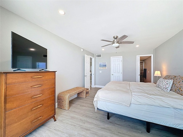 1100 Tarpon Center Dr Unit 503-5C, Venice, FL 34285 - bedroom featuring light wood-style floors, recessed lighting, ceiling fan, and connected bathroom