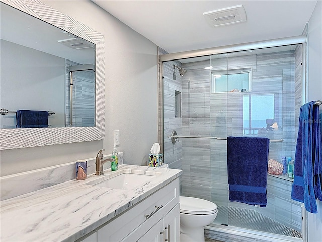1100 Tarpon Center Dr Unit 503-5C, Venice, FL 34285 - bathroom with vanity, toilet, and a stall shower
