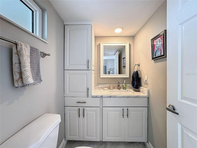 1100 Tarpon Center Dr Unit 503-5C, Venice, FL 34285 - bathroom featuring vanity, toilet, and baseboards