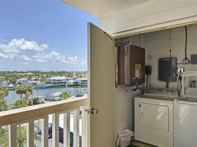 1100 Tarpon Center Dr Unit 503-5C, Venice, FL 34285 - laundry area with electric panel, washing machine and dryer, a water view, and healthy amount of natural light
