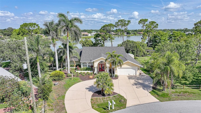 249 Hallcrest Ter, Port Charlotte, FL 33954 - view of front of property with driveway, an attached garage, a water view, and view of wooded area