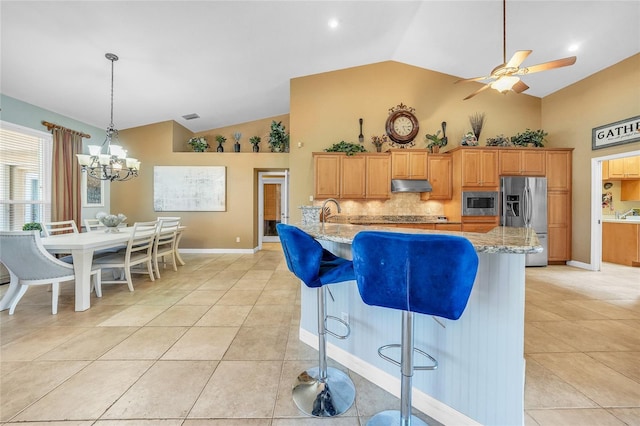 249 Hallcrest Ter, Port Charlotte, FL 33954 - kitchen featuring appliances with stainless steel finishes, under cabinet range hood, high vaulted ceiling, tasteful backsplash, and light tile patterned floors