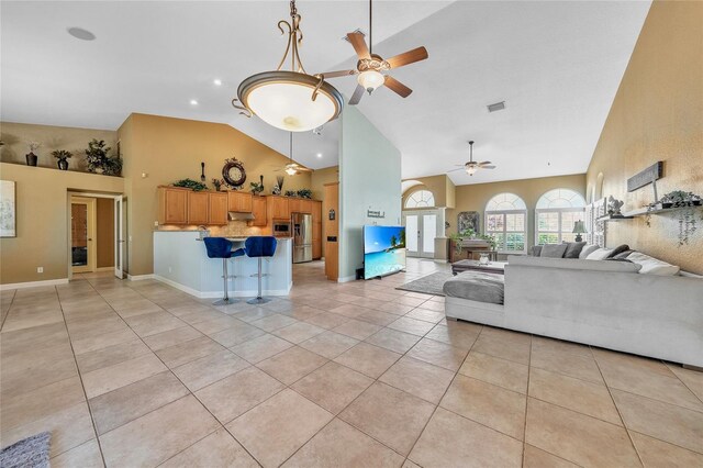 249 Hallcrest Ter, Port Charlotte, FL 33954 - living area featuring ceiling fan, high vaulted ceiling, light tile patterned floors, and baseboards