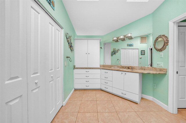 249 Hallcrest Ter, Port Charlotte, FL 33954 - bathroom with a closet, baseboards, tile patterned flooring, and vanity