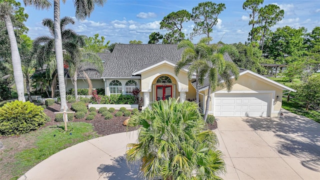 249 Hallcrest Ter, Port Charlotte, FL 33954 - view of front of property with french doors, driveway, stucco siding, and an attached garage