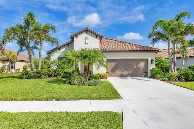 213 Malina Ct, Nokomis, FL 34275 - mediterranean / spanish house with an attached garage, driveway, a tile roof, a front lawn, and stucco siding