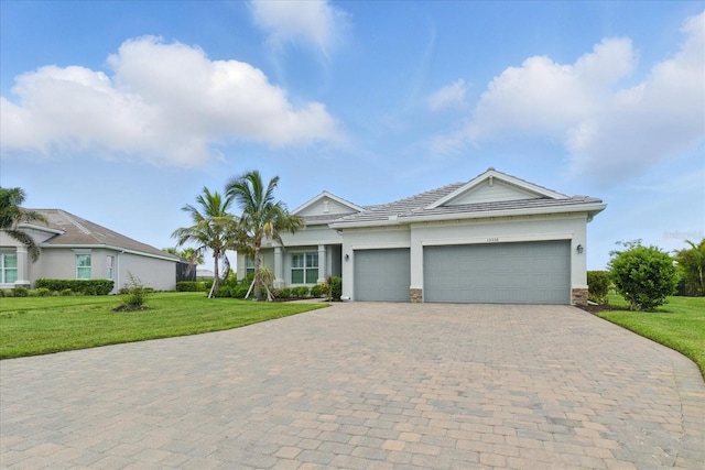 15336 Spanish Point Dr, Port Charlotte, FL 33981 - single story home featuring decorative driveway, an attached garage, a front lawn, stone siding, and stucco siding