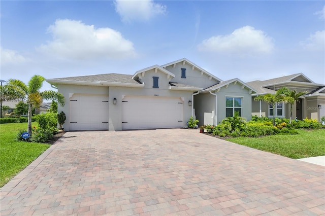 15963 Crofton Springs Way, Port Charlotte, FL 33953 - view of front of home with stucco siding, decorative driveway, a garage, and a front lawn