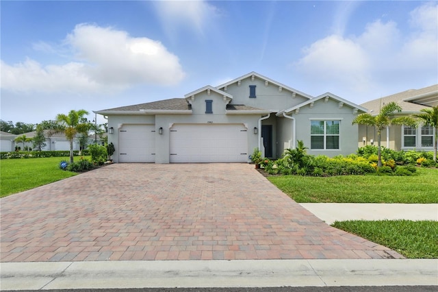 15963 Crofton Springs Way, Port Charlotte, FL 33953 - view of front of house featuring stucco siding, decorative driveway, a garage, and a front lawn