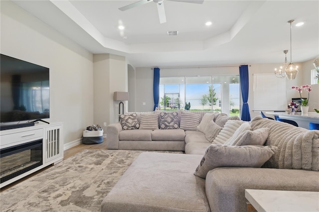 15963 Crofton Springs Way, Port Charlotte, FL 33953 - living area with a tray ceiling, a chandelier, ceiling fan, wood finished floors, and recessed lighting