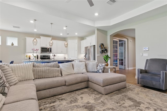 15963 Crofton Springs Way, Port Charlotte, FL 33953 - living room with arched walkways, a ceiling fan, light wood finished floors, recessed lighting, and baseboards