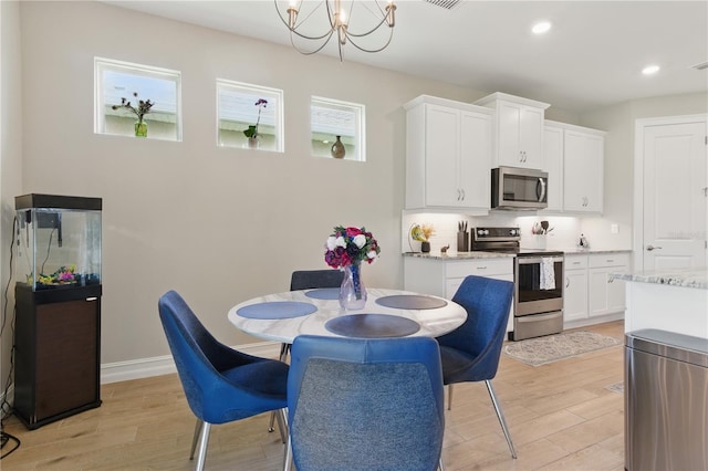 15963 Crofton Springs Way, Port Charlotte, FL 33953 - dining area featuring light wood-type flooring, a chandelier, recessed lighting, and baseboards