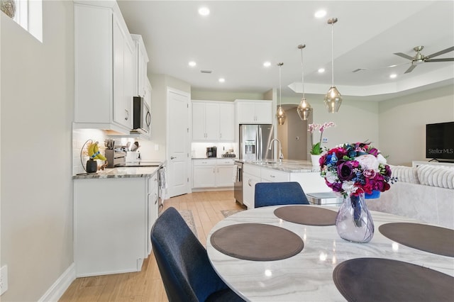 15963 Crofton Springs Way, Port Charlotte, FL 33953 - dining room featuring recessed lighting, light wood finished floors, a ceiling fan, and baseboards