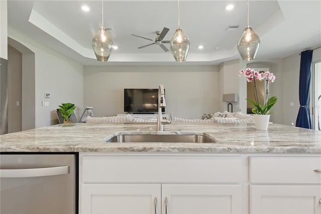 15963 Crofton Springs Way, Port Charlotte, FL 33953 - kitchen featuring open floor plan, stainless steel dishwasher, a sink, white cabinetry, and light stone counters